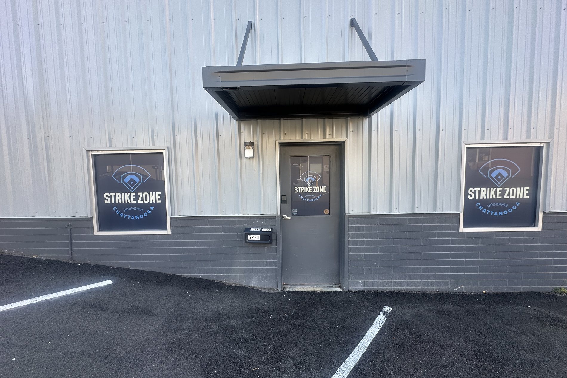 Costa-installed storefront window and door signage for Strike Zone Chattanooga